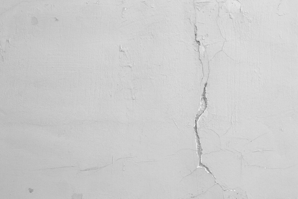 Damaged drywall with a small crack caused by settling